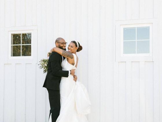Groom lifting the bride outside the venue